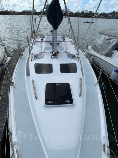 deck with a hatch and 2 cabin windows at the front