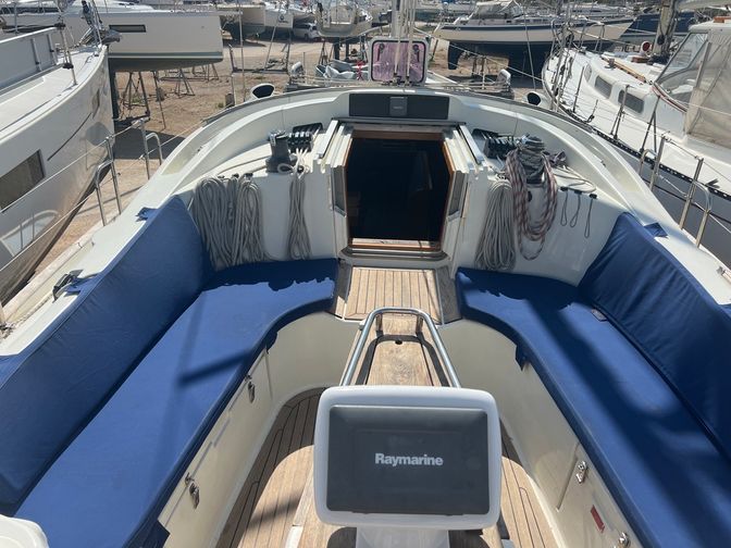 cockpit area with surrounded seating and the entrance to the boat cabin